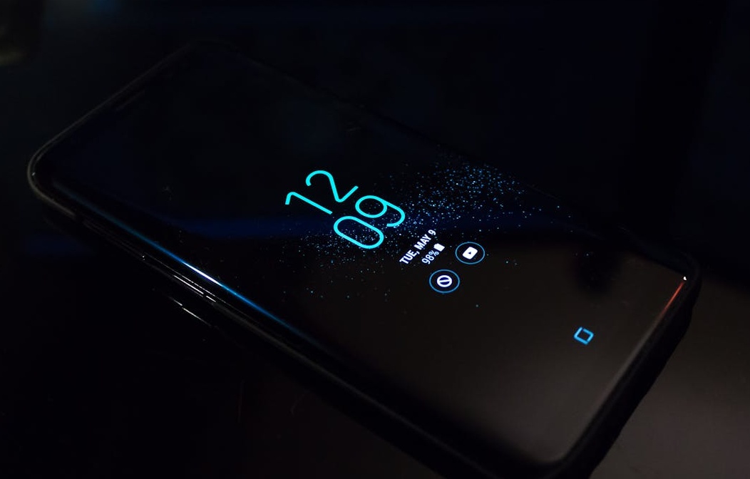 A person intently watching a video on their smartphone, representing a Facebook viewer