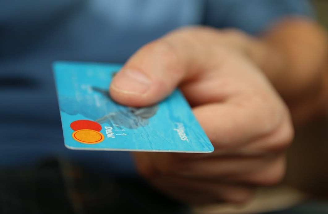 一只手正在使用信用卡进行安全的线上支付，代表选择可靠的服务商