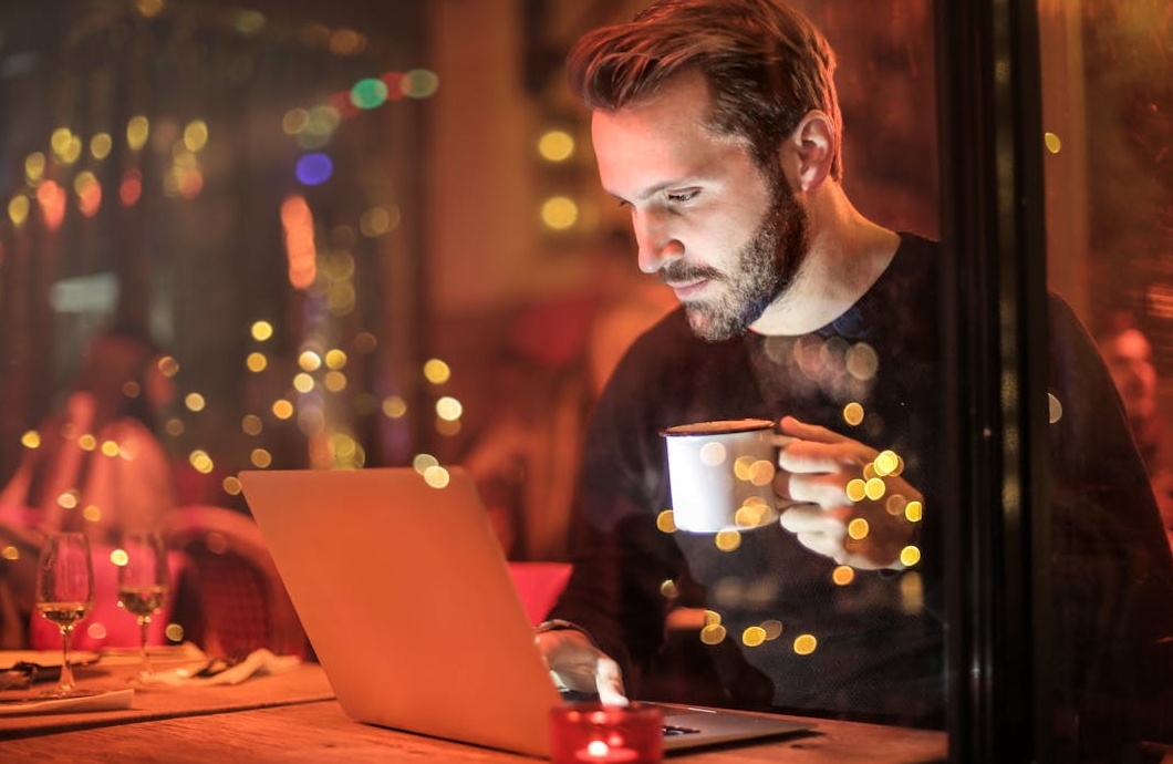 用户在咖啡馆里开心地使用手机浏览社交媒体