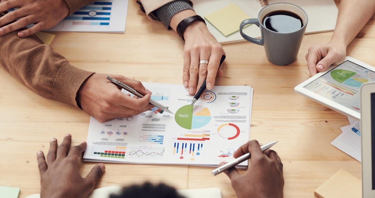 A team of marketing professionals analyzing data on a digital dashboard